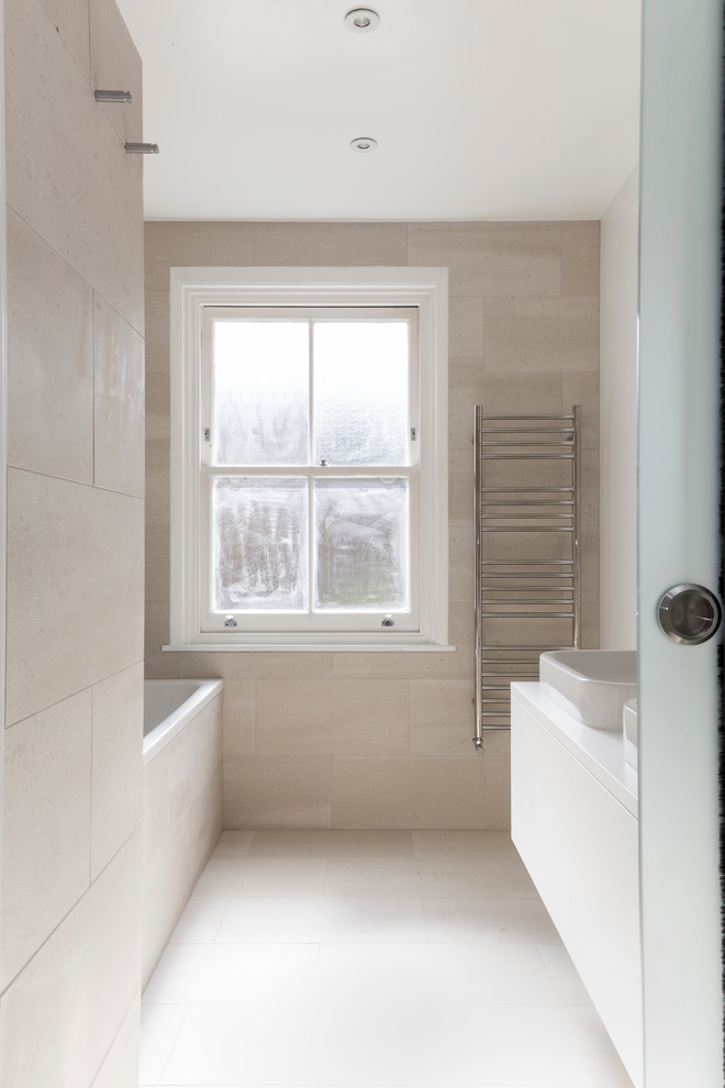 Small contemporary family bathroom in London with flat-panel cabinets, white cabinets, a built-in bath, a walk-in shower, a wall mounted toilet, beige tiles, porcelain tiles, beige walls, porcelain flooring, a built-in sink, quartz worktops, beige floors and a sliding door.