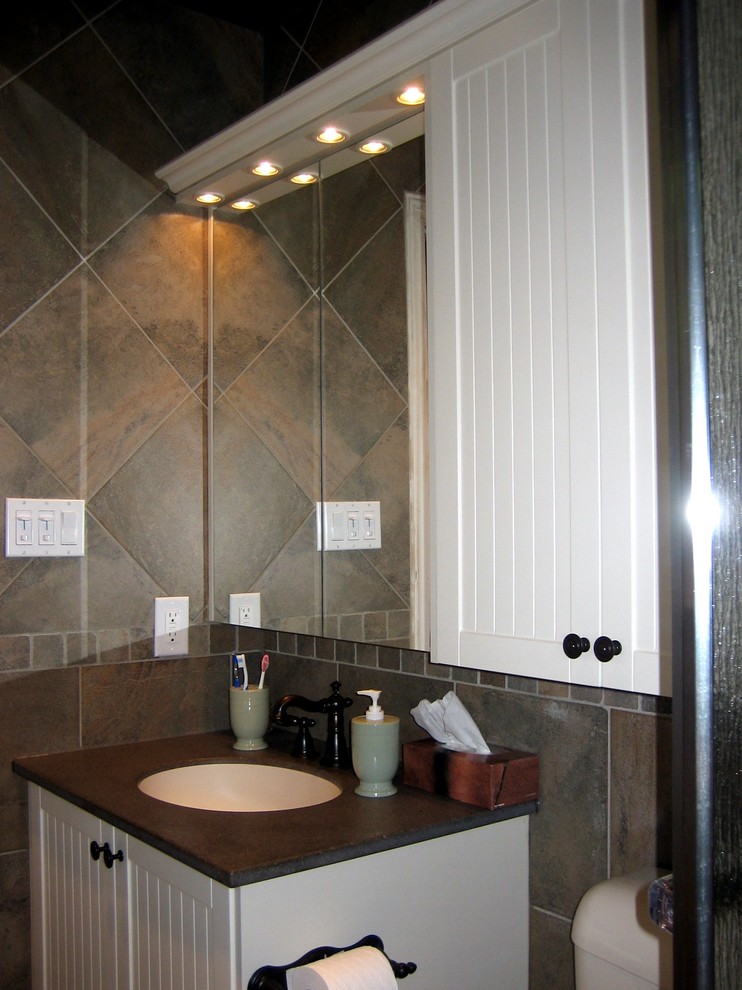 Example of a mid-sized classic master green tile and porcelain tile porcelain tile alcove shower design in Toronto with an integrated sink, shaker cabinets, beige cabinets, solid surface countertops, a two-piece toilet and green walls