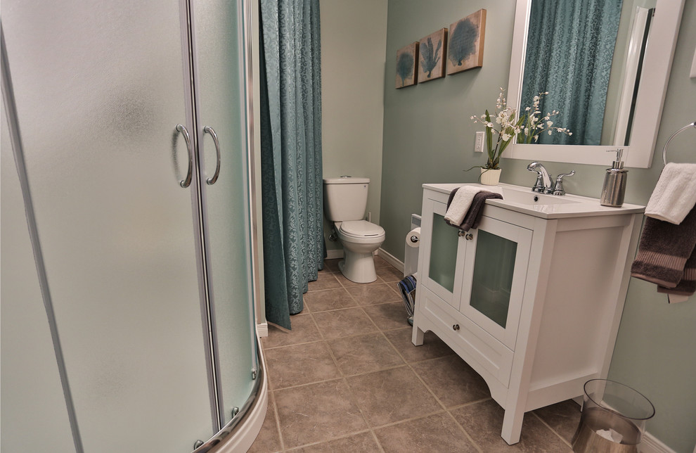 Small classic shower room bathroom in Other with an integrated sink, shaker cabinets, white cabinets, quartz worktops, a corner shower, a two-piece toilet, grey tiles, porcelain tiles, blue walls and porcelain flooring.