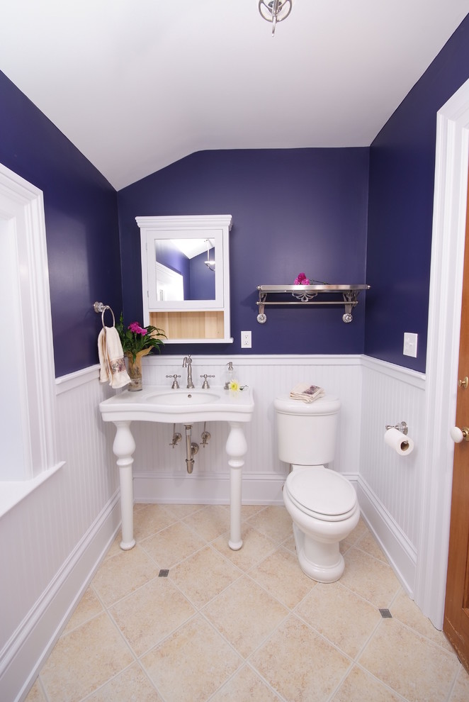 Example of a classic beige floor claw-foot bathtub design in Cleveland with a console sink and purple walls
