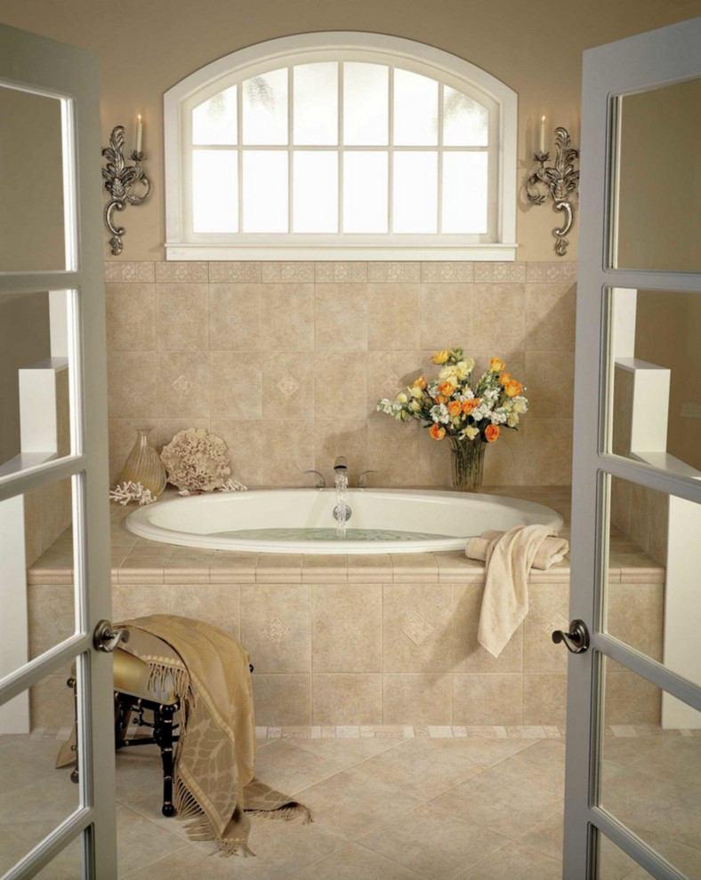 Design ideas for a medium sized traditional ensuite bathroom in Providence with shaker cabinets, light wood cabinets, ceramic tiles, blue walls, porcelain flooring, a submerged sink, quartz worktops, an alcove bath and beige floors.