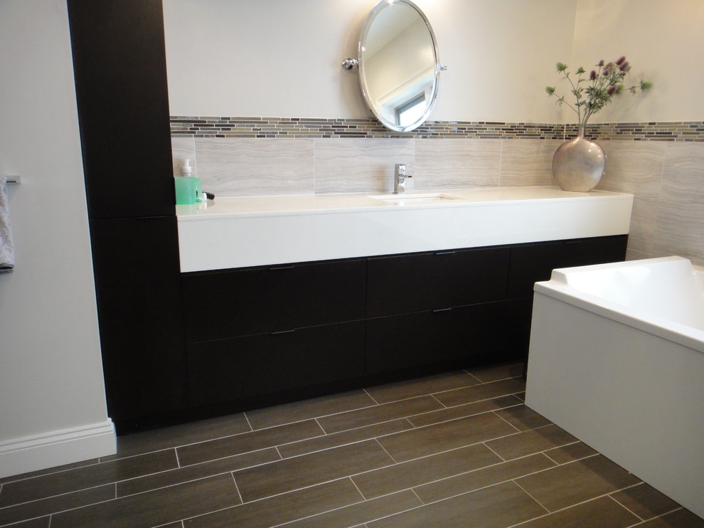 Example of a large trendy master multicolored tile and porcelain tile porcelain tile bathroom design in New York with a drop-in sink, flat-panel cabinets, dark wood cabinets, marble countertops, a one-piece toilet and beige walls