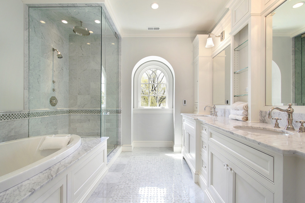 Doorless shower - mid-sized traditional master white tile and porcelain tile porcelain tile and white floor doorless shower idea in New York with glass-front cabinets, white cabinets, a hot tub, a two-piece toilet, white walls, an undermount sink, marble countertops and a hinged shower door
