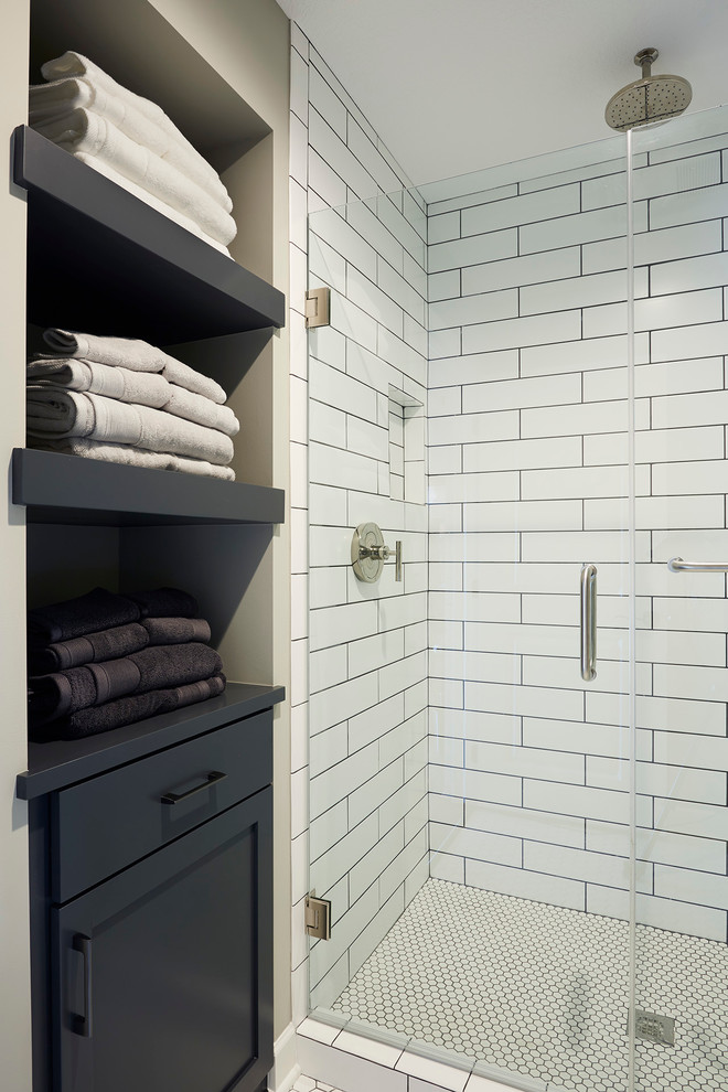 Large transitional 3/4 white tile and subway tile ceramic tile doorless shower photo in Minneapolis with shaker cabinets, distressed cabinets, a one-piece toilet, gray walls, marble countertops and an undermount sink