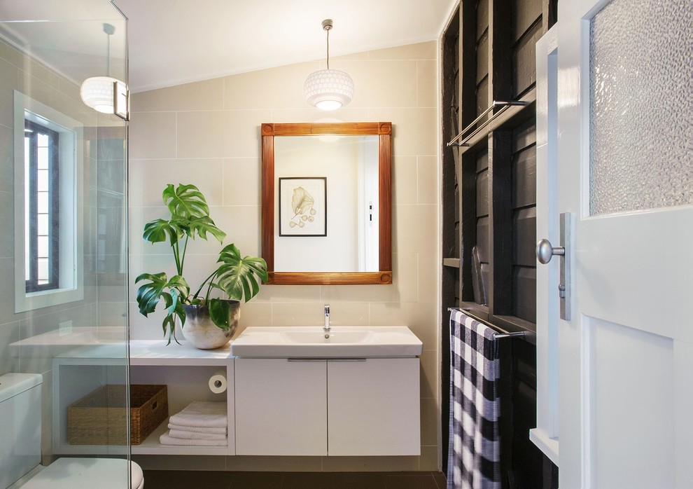 Medium sized contemporary family bathroom in Brisbane with freestanding cabinets, medium wood cabinets, a corner shower, a one-piece toilet, beige tiles, ceramic tiles, black walls, ceramic flooring, an integrated sink, solid surface worktops, green floors and a hinged door.