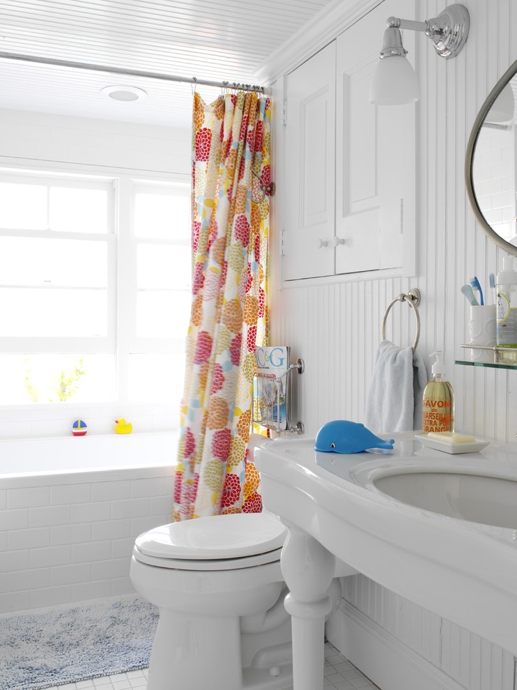 Example of a mid-sized beach style kids' white tile and subway tile porcelain tile bathroom design in New York with a console sink, raised-panel cabinets, white cabinets, a two-piece toilet, white walls and solid surface countertops
