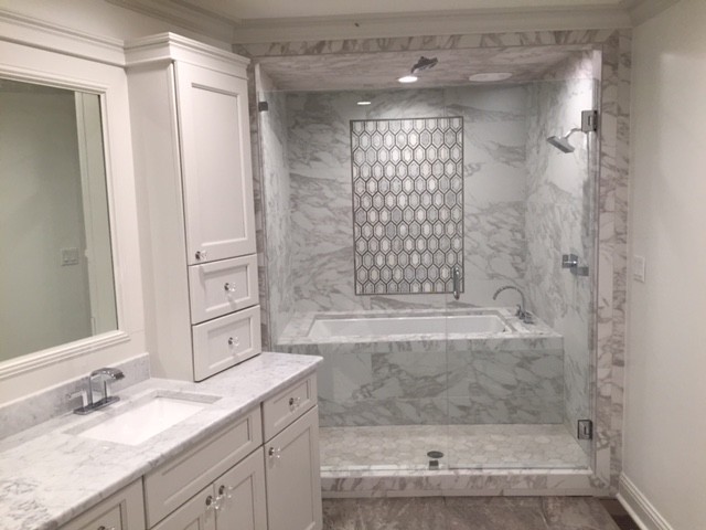 Mid-sized trendy master gray tile, white tile and marble tile marble floor and gray floor tub/shower combo photo in Jackson with shaker cabinets, white cabinets, an undermount tub, white walls, an undermount sink, marble countertops and a hinged shower door