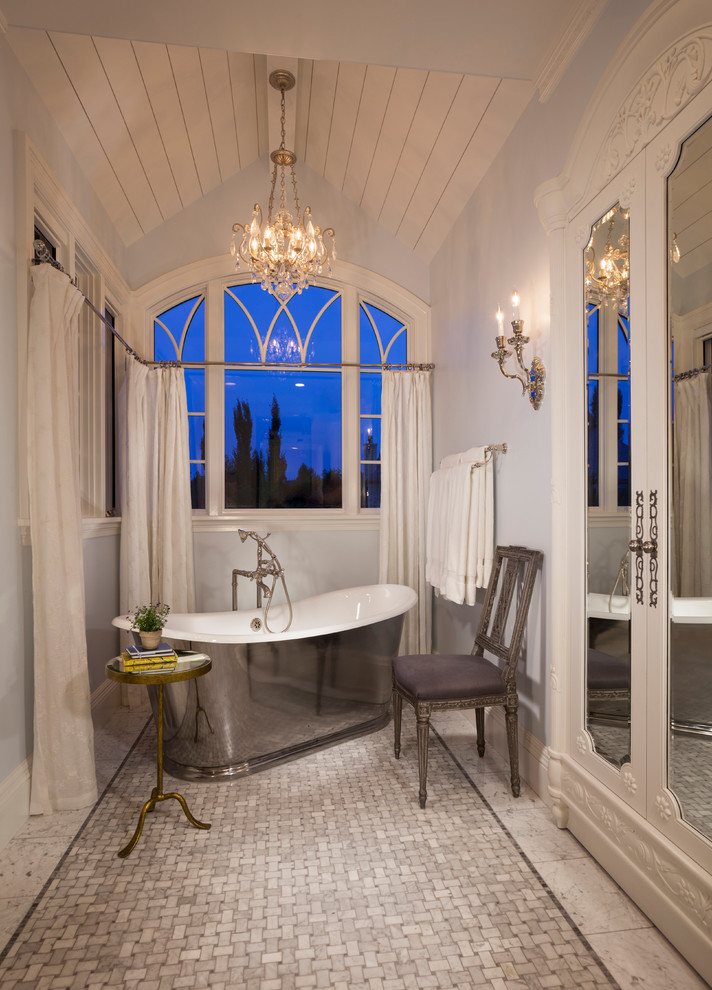 Design ideas for a victorian bathroom in Salt Lake City with white cabinets, a freestanding bath and grey tiles.