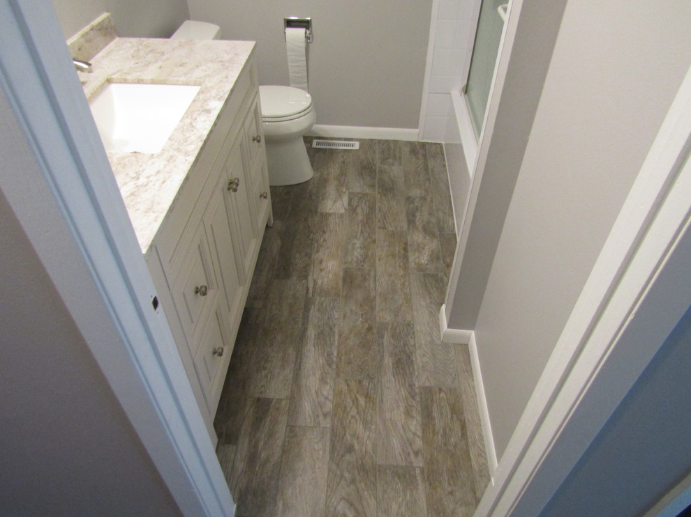 Photo of a small traditional family bathroom in Milwaukee with porcelain flooring and brown floors.