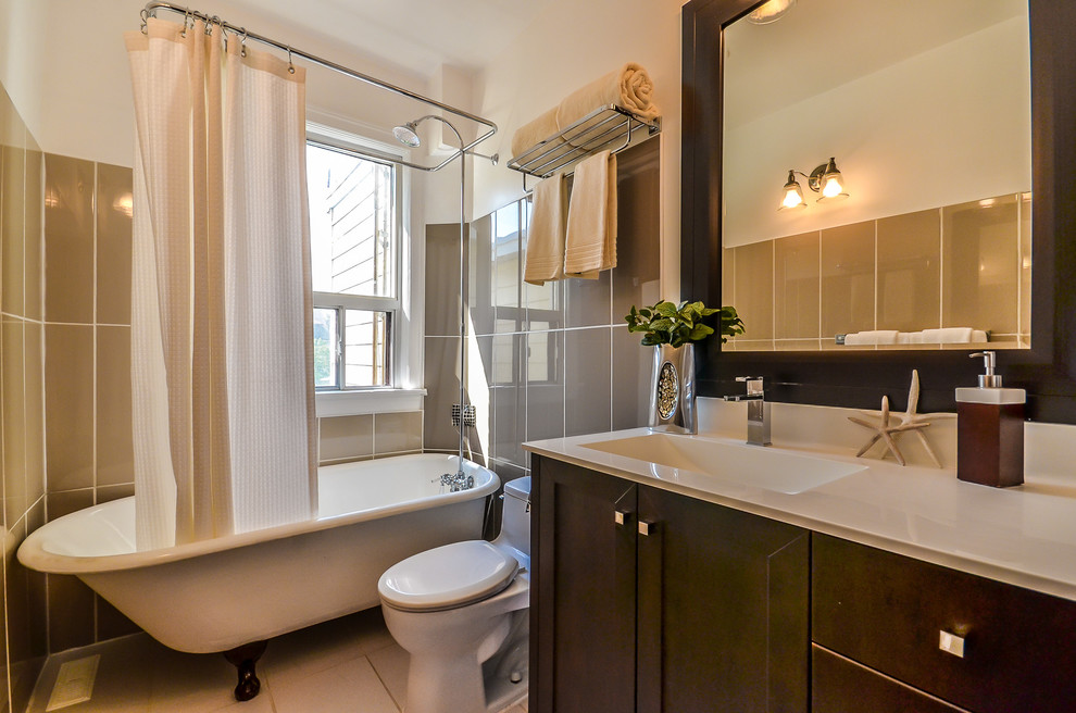 Example of a mid-sized trendy 3/4 beige tile and porcelain tile porcelain tile bathroom design in Toronto with an integrated sink, shaker cabinets, dark wood cabinets, granite countertops, white walls and a two-piece toilet
