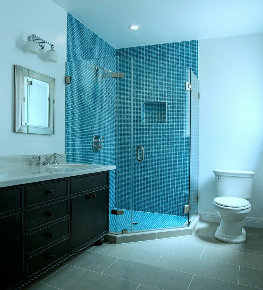 Example of a mid-sized transitional master blue tile and mosaic tile ceramic tile corner shower design in San Francisco with an undermount sink, furniture-like cabinets, dark wood cabinets, quartz countertops, a two-piece toilet and white walls