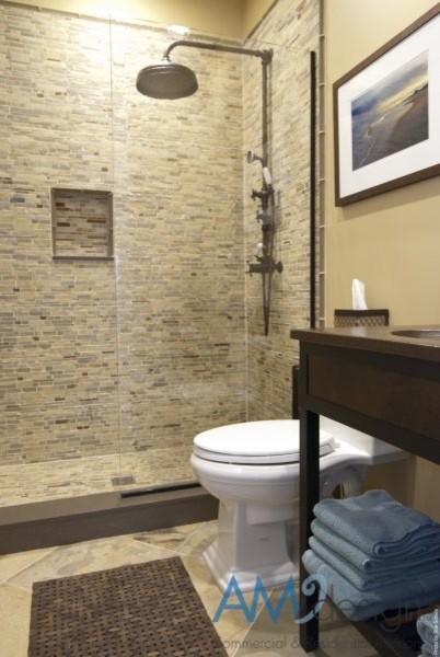 Inspiration for a large transitional master beige tile and stone tile ceramic tile alcove shower remodel in New York with a drop-in sink, recessed-panel cabinets, dark wood cabinets, a one-piece toilet and brown walls