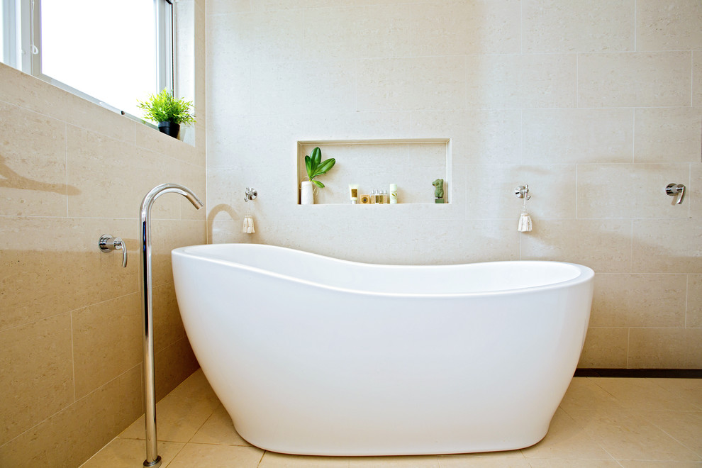 Freestanding bathtub - mid-sized contemporary master beige tile travertine floor freestanding bathtub idea in Sydney with raised-panel cabinets, dark wood cabinets, quartz countertops and beige walls