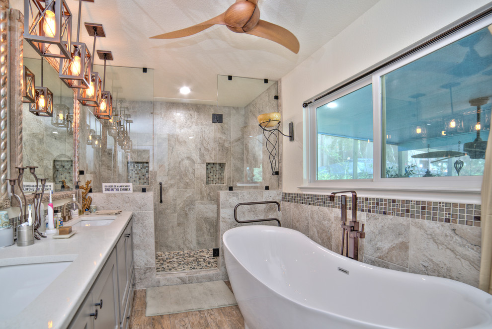 Bathroom - small modern master multicolored tile and ceramic tile ceramic tile and brown floor bathroom idea in Austin with shaker cabinets, gray cabinets, a one-piece toilet, white walls, an undermount sink, quartz countertops and a hinged shower door