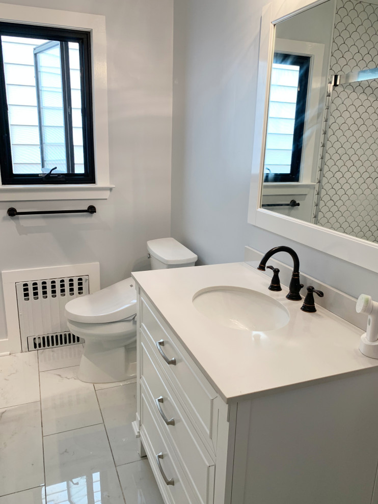 Design ideas for a small contemporary ensuite bathroom in New York with shaker cabinets, white cabinets, an alcove shower, a one-piece toilet, white tiles, ceramic tiles, grey walls, ceramic flooring, a submerged sink, quartz worktops, white floors, a sliding door, white worktops, a single sink and a freestanding vanity unit.