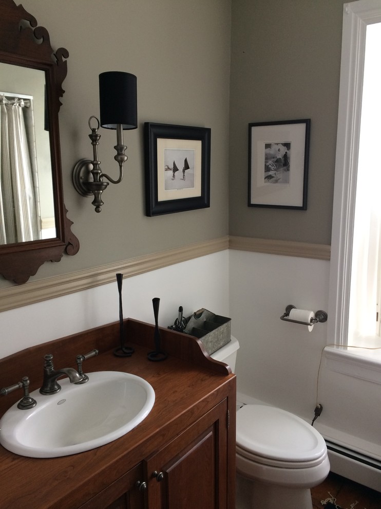 Inspiration for a small transitional 3/4 white tile and stone tile dark wood floor and brown floor bathroom remodel in Philadelphia with raised-panel cabinets, dark wood cabinets, a two-piece toilet, gray walls, a drop-in sink and wood countertops