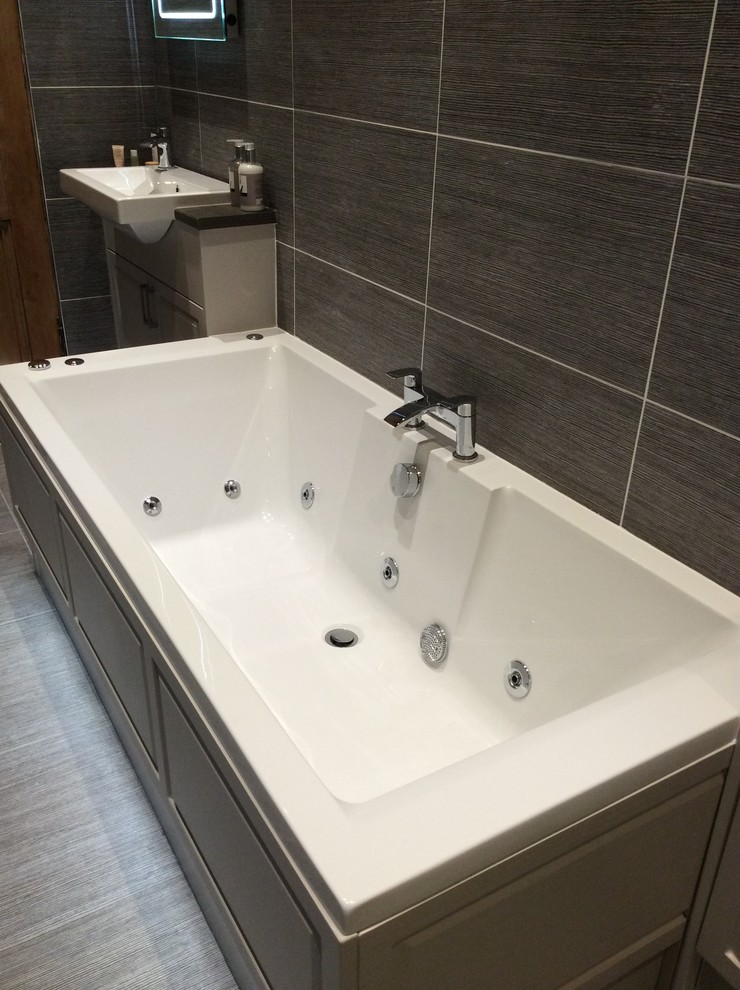 Example of a trendy ceramic tile bathroom design in Glasgow with beige walls and a drop-in sink