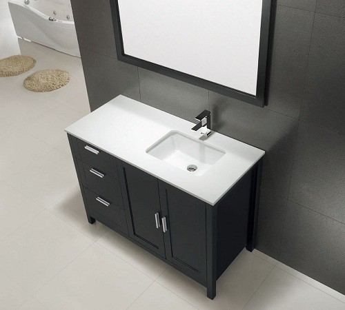 Example of a large trendy master porcelain tile freestanding bathtub design in Calgary with recessed-panel cabinets, black cabinets, a one-piece toilet, black walls, an integrated sink and solid surface countertops