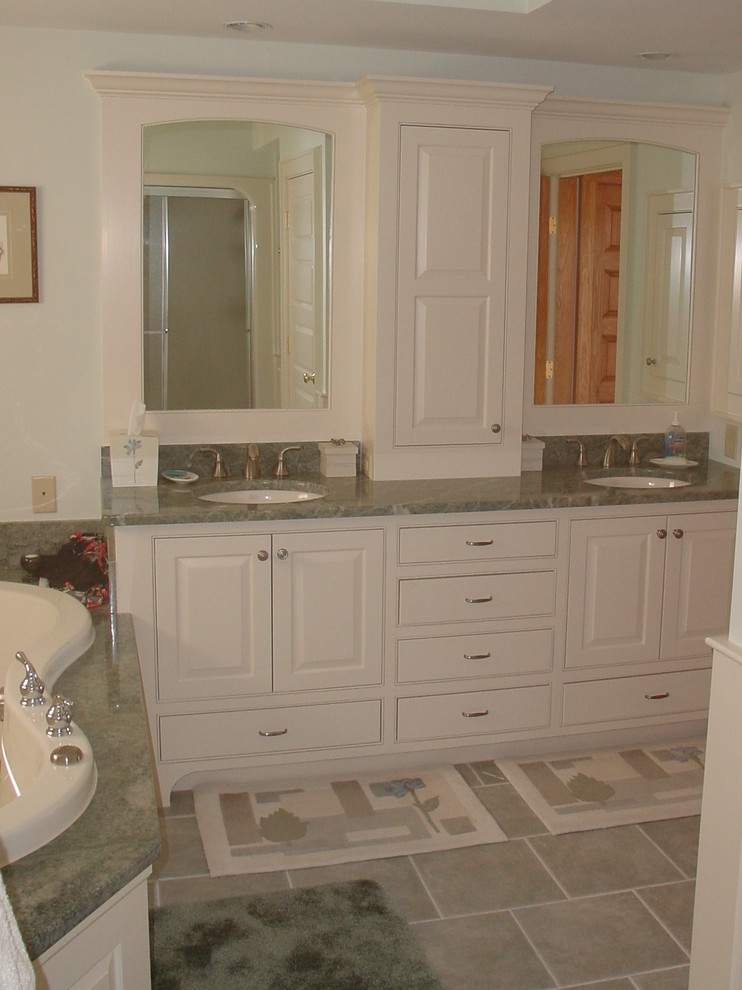 This is an example of a traditional bathroom in Portland Maine with a submerged sink, a built-in bath, raised-panel cabinets, white cabinets, granite worktops and green tiles.