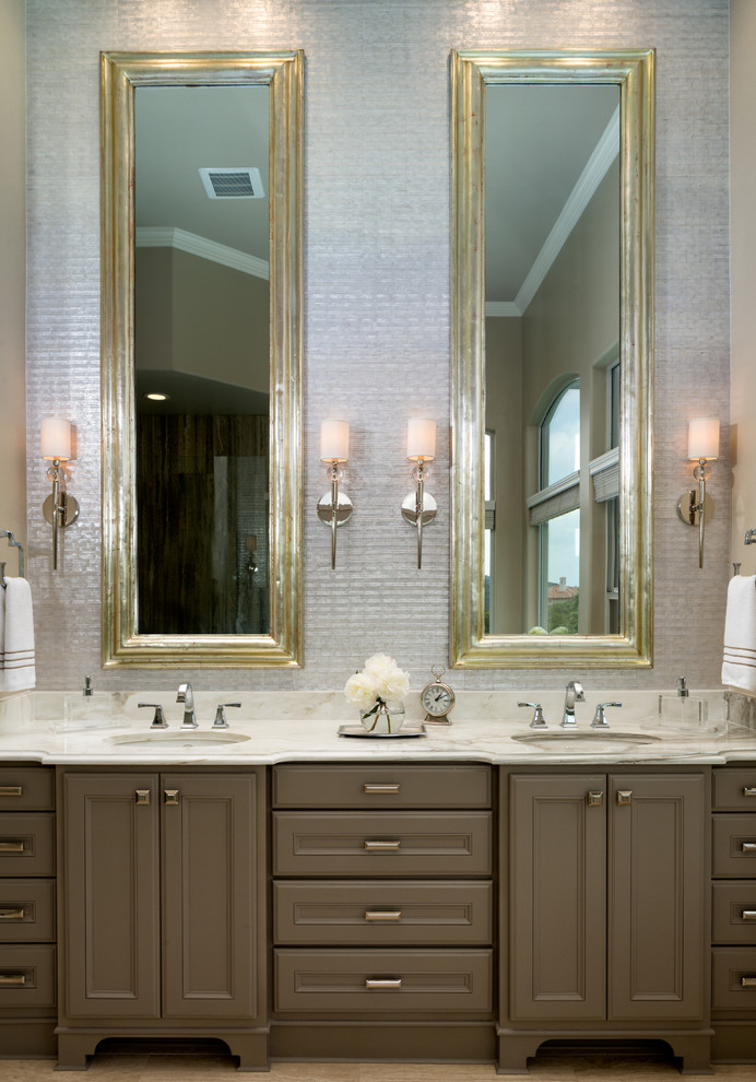 オースティンにあるトランジショナルスタイルのおしゃれな浴室 (アンダーカウンター洗面器、落し込みパネル扉のキャビネット、茶色いキャビネット、グレーの壁) の写真