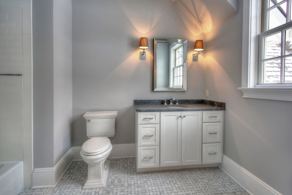 Bathroom - mid-sized transitional gray tile and subway tile marble floor and white floor bathroom idea in New York with an undermount sink, shaker cabinets, white cabinets, a one-piece toilet, gray walls and granite countertops