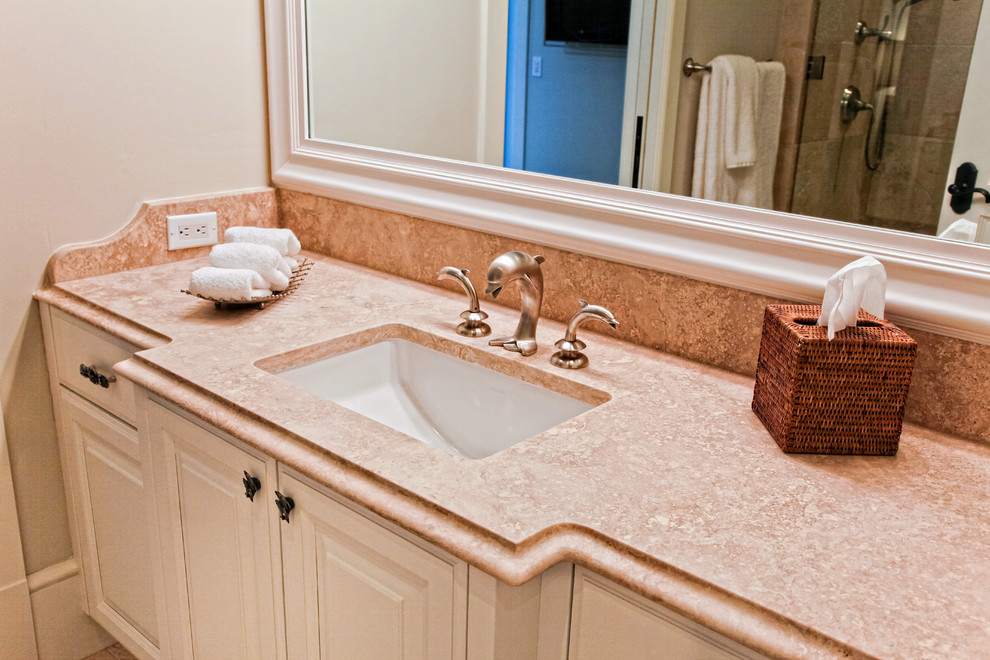 Bathroom - mid-sized traditional bathroom idea in Miami with raised-panel cabinets, white cabinets, beige walls, an undermount sink and granite countertops