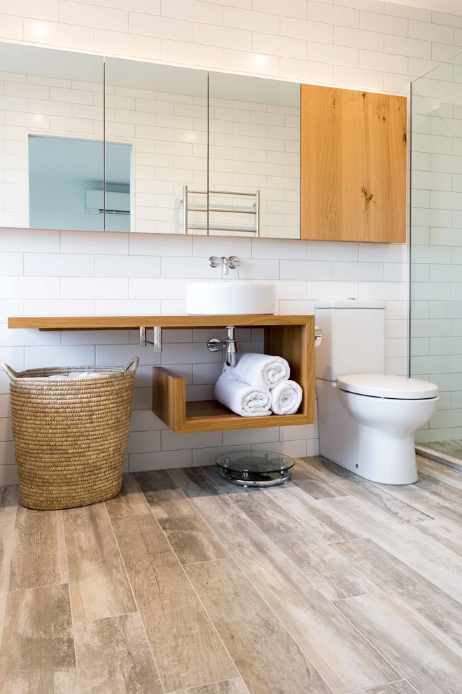Design ideas for a contemporary bathroom in Auckland with a vessel sink and white tiles.