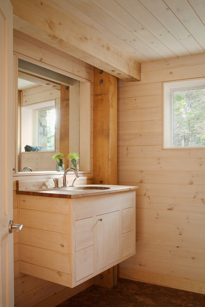 Modelo de cuarto de baño rústico con puertas de armario de madera clara