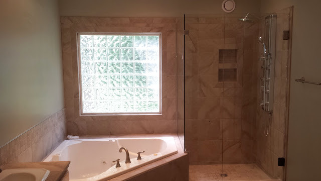 Inspiration for a mid-sized transitional master beige tile and porcelain tile bathroom remodel in Atlanta with beige walls, a drop-in sink and a hinged shower door
