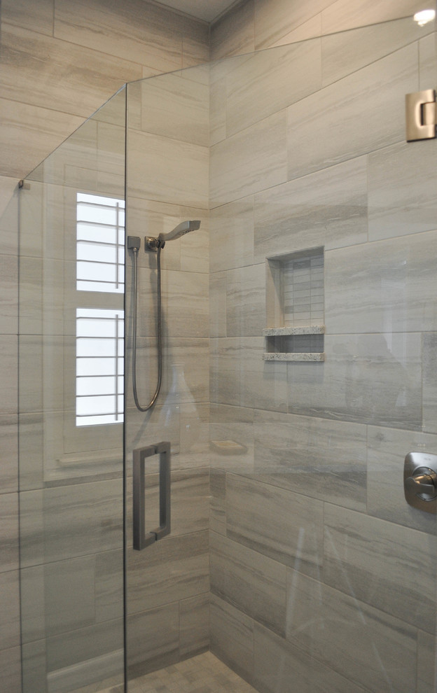 Inspiration for a mid-sized modern 3/4 gray tile and porcelain tile corner shower remodel in Other with gray walls and a hinged shower door