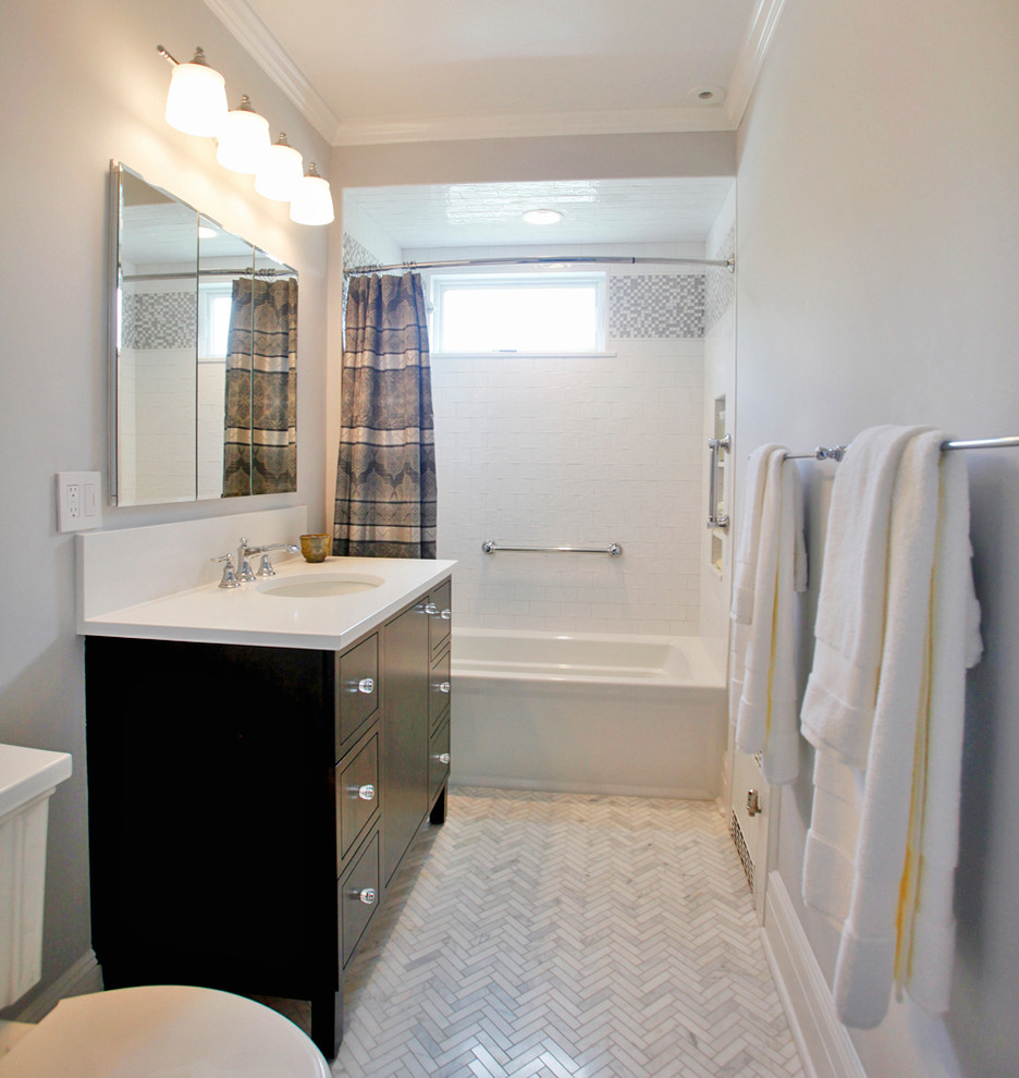 Inspiration for a small transitional white tile and ceramic tile marble floor and gray floor bathroom remodel in New York with flat-panel cabinets, dark wood cabinets, a two-piece toilet, gray walls, an undermount sink and quartz countertops