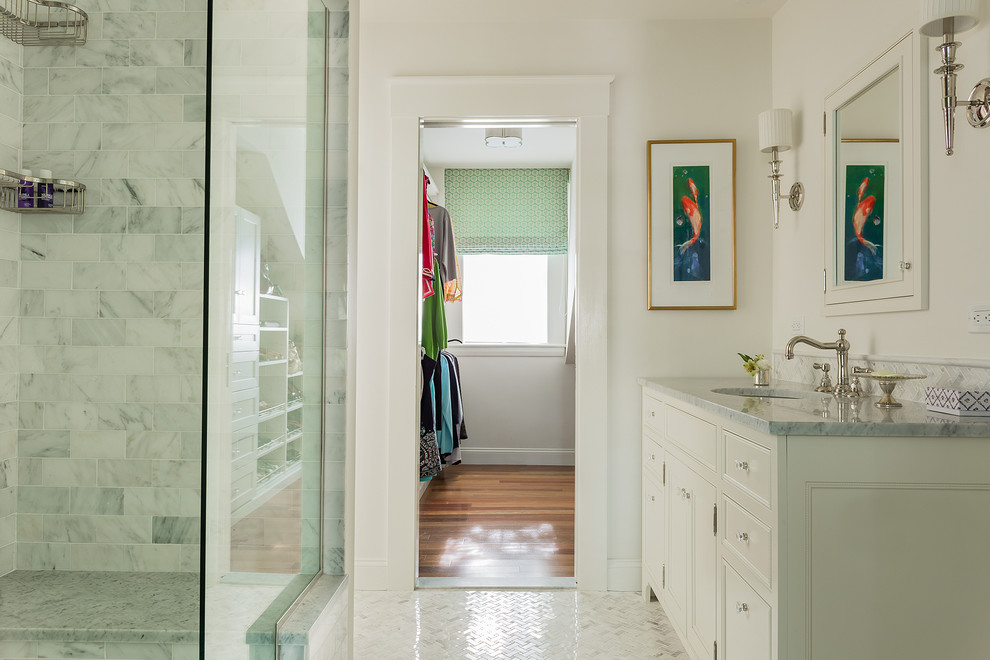 Example of a mid-sized classic white tile and stone tile mosaic tile floor alcove shower design in Boston with white cabinets, white walls, an undermount sink and raised-panel cabinets