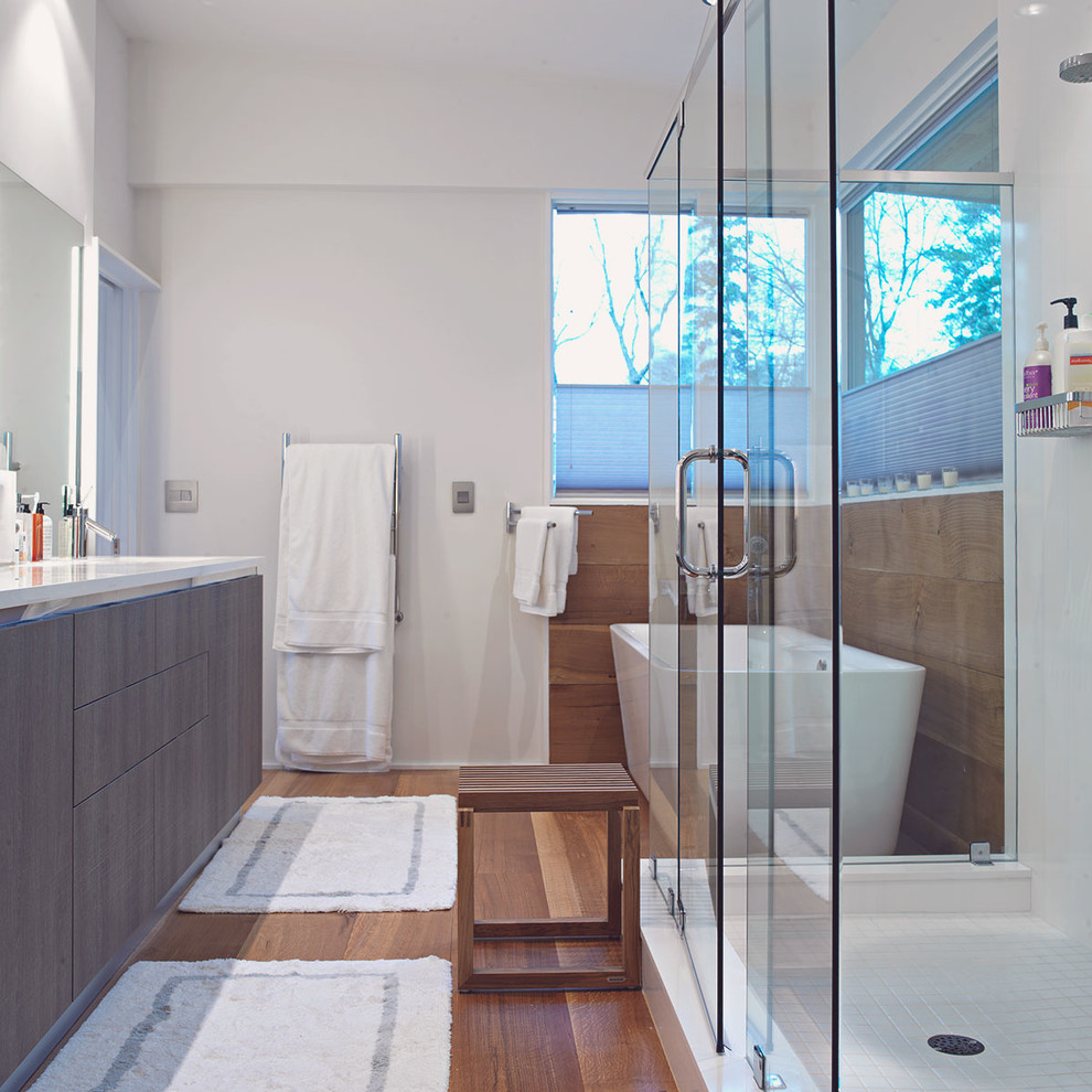 Example of a mid-sized minimalist master medium tone wood floor bathroom design in Atlanta with flat-panel cabinets and gray cabinets