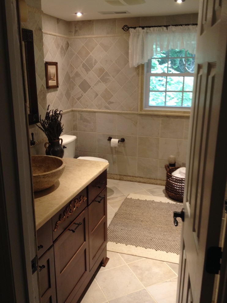 Photo of a medium sized traditional shower room bathroom in Atlanta with a vessel sink, raised-panel cabinets, dark wood cabinets, laminate worktops, a shower/bath combination, a bidet, grey tiles, grey walls and ceramic flooring.