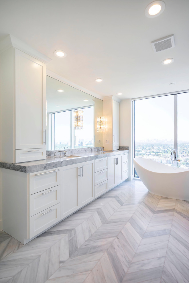 Photo of a large modern ensuite bathroom in Houston with shaker cabinets, white cabinets, a freestanding bath, a corner shower, a submerged sink, marble worktops, white worktops, double sinks and a built in vanity unit.