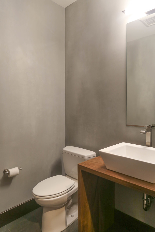This is an example of a small modern shower room bathroom in Other with open cabinets, medium wood cabinets, a two-piece toilet, grey tiles, porcelain tiles, grey walls, porcelain flooring, a vessel sink and wooden worktops.