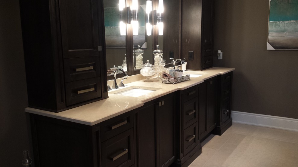 Inspiration for a medium sized contemporary ensuite bathroom in Toronto with recessed-panel cabinets, dark wood cabinets, beige tiles, brown walls, limestone flooring, a submerged sink, limestone worktops and beige floors.