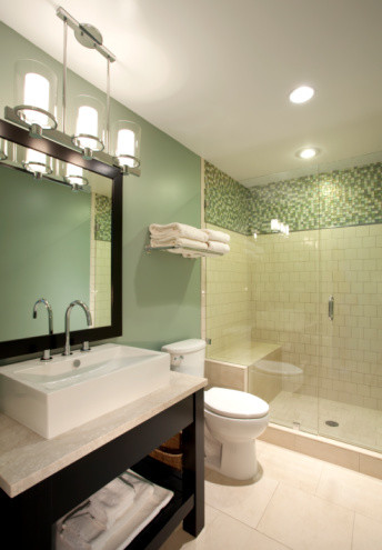 Doorless shower - small traditional 3/4 green tile porcelain tile doorless shower idea in Los Angeles with a vessel sink, open cabinets, dark wood cabinets, limestone countertops, a two-piece toilet and multicolored walls