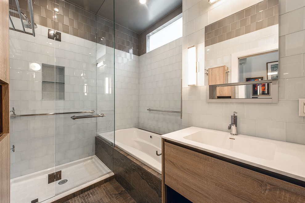 Drop-in bathtub - small modern master white tile and glass tile ceramic tile drop-in bathtub idea in San Francisco with furniture-like cabinets, light wood cabinets, a wall-mount toilet, white walls, an integrated sink and laminate countertops
