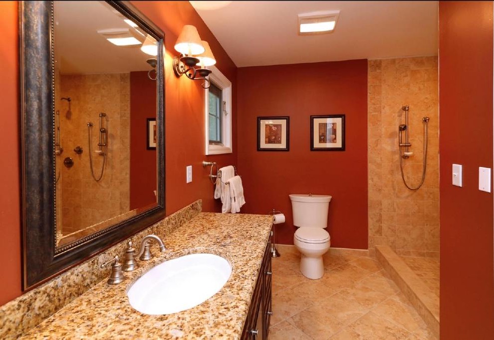 Photo of a medium sized traditional ensuite bathroom in Other with a submerged sink, raised-panel cabinets, dark wood cabinets, granite worktops, a walk-in shower, a one-piece toilet, beige tiles, ceramic tiles, red walls and ceramic flooring.