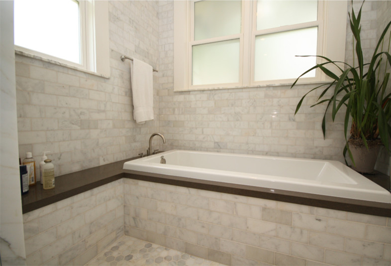 Drop-in bathtub - contemporary stone tile drop-in bathtub idea in Austin with quartz countertops