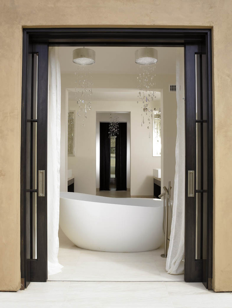 Modern bathroom in San Diego with a freestanding bath and white tiles.