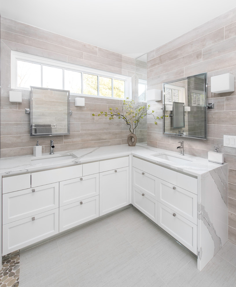 Walk-in shower - mid-sized contemporary master gray tile and porcelain tile porcelain tile and white floor walk-in shower idea in New York with recessed-panel cabinets, white cabinets, gray walls, an undermount sink, quartz countertops and a hinged shower door