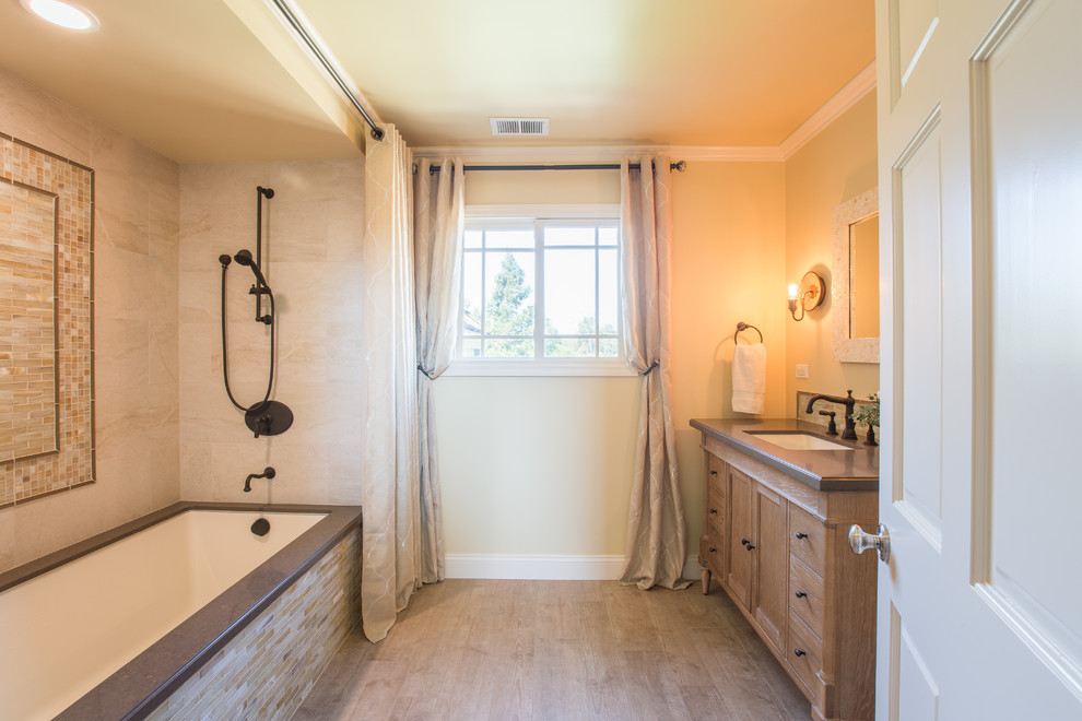 Inspiration for a large timeless beige tile and porcelain tile porcelain tile tub/shower combo remodel in San Francisco with an undermount sink, recessed-panel cabinets, quartz countertops, an undermount tub and yellow walls