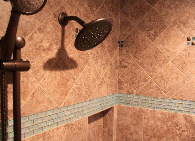Inspiration for a medium sized traditional ensuite bathroom in Philadelphia with a built-in sink, raised-panel cabinets, medium wood cabinets, limestone worktops, a built-in bath, a corner shower, a two-piece toilet, multi-coloured tiles, stone tiles, multi-coloured walls and medium hardwood flooring.
