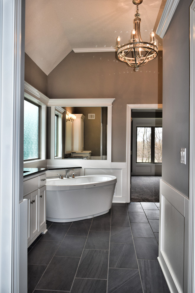 Large elegant master porcelain tile and gray floor bathroom photo in Kansas City with flat-panel cabinets, white cabinets, beige walls, an undermount sink, granite countertops and a hinged shower door