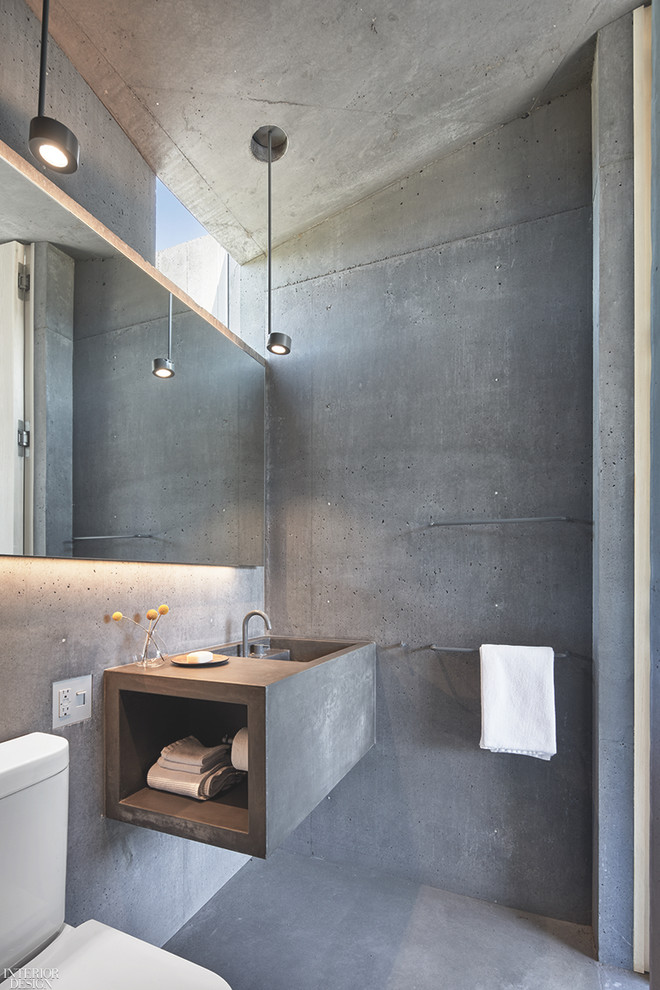 Inspiration pour une salle de bain urbaine de taille moyenne avec un mur gris, sol en béton ciré, un lavabo intégré, un plan de toilette en béton, un sol gris et un plan de toilette gris.