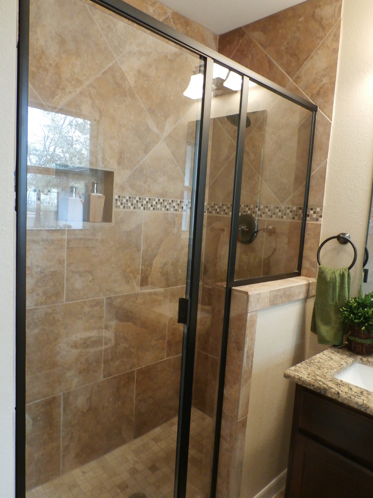 Photo of a small traditional ensuite bathroom in Austin with a submerged sink, flat-panel cabinets, medium wood cabinets, granite worktops, an alcove shower, a two-piece toilet, multi-coloured tiles, ceramic tiles, beige walls and ceramic flooring.