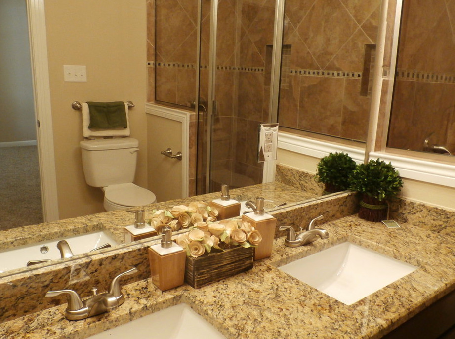 This is an example of a medium sized classic ensuite half tiled bathroom in Austin with a submerged sink, flat-panel cabinets, medium wood cabinets, granite worktops, a double shower, a two-piece toilet, beige tiles, ceramic tiles, beige walls and ceramic flooring.