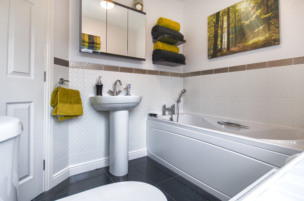 На фото: маленькая ванная комната в классическом стиле с накладной ванной, душем над ванной, черно-белой плиткой, зеленой плиткой, белой плиткой, белыми стенами, полом из терраццо и раковиной с пьедесталом для на участке и в саду